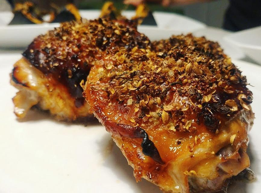 close up of skin-on golden crusted chicken thighs