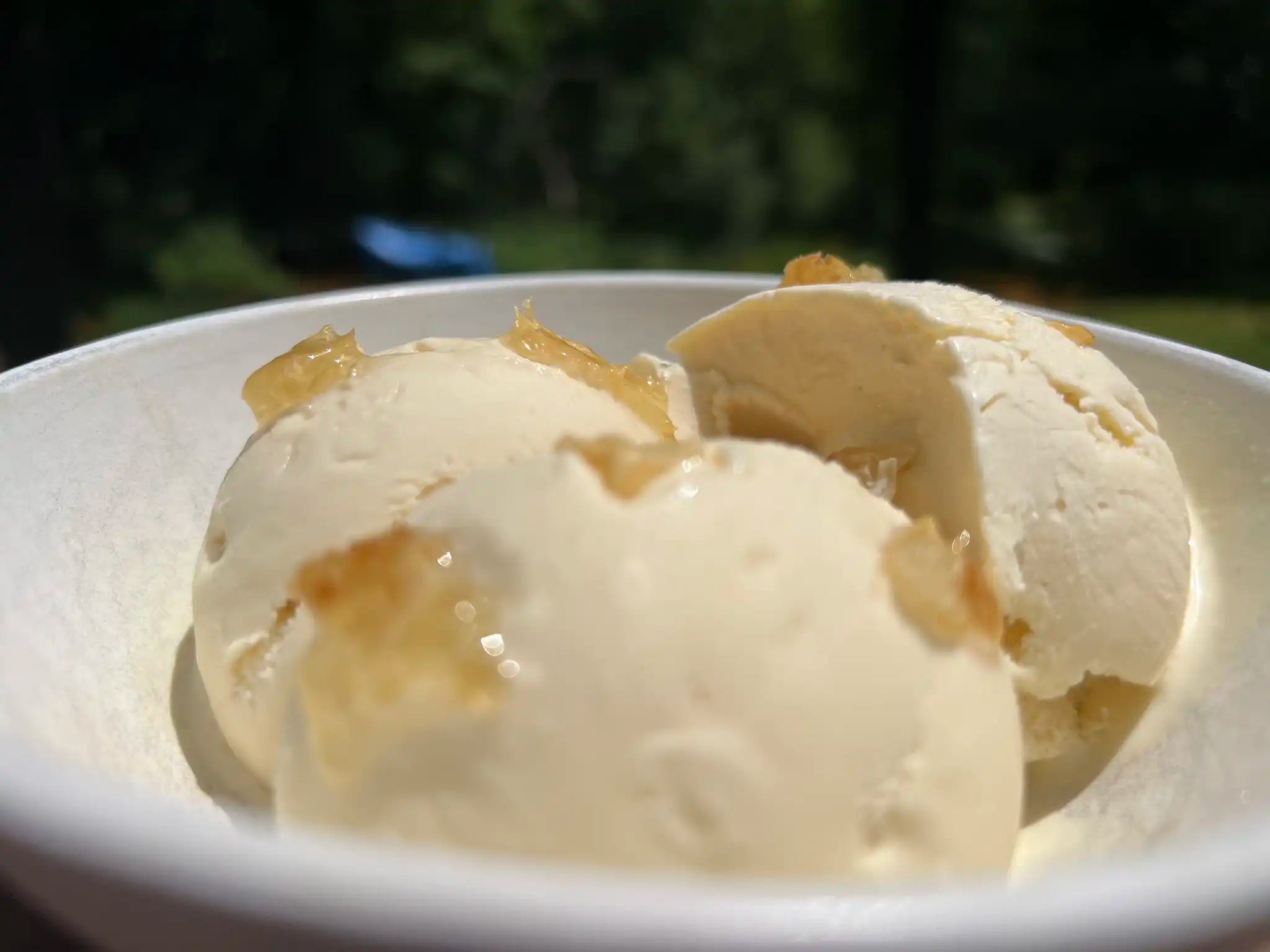 Closeup of honey vanilla ice cream studded with pieces of honeycomb