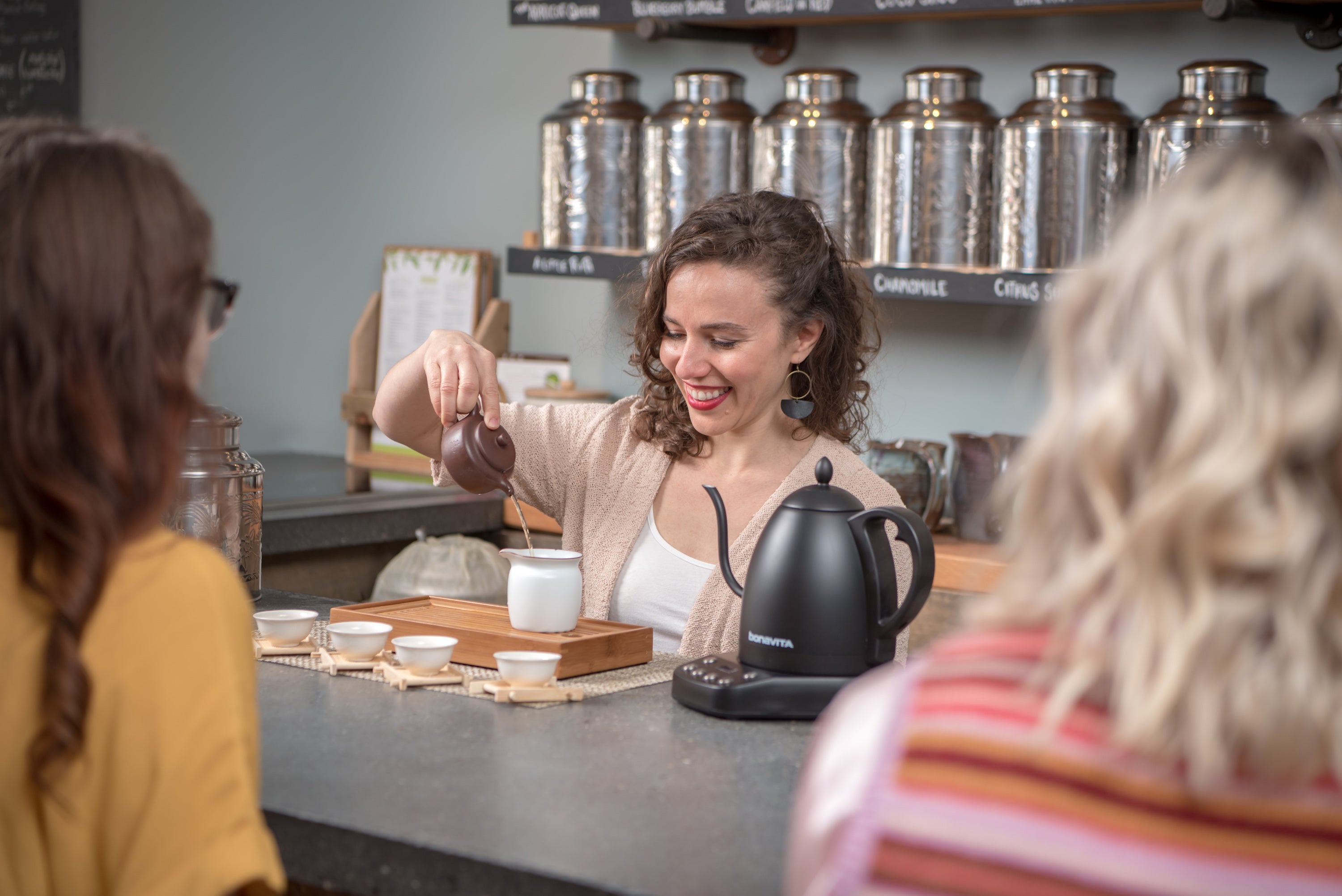 woman preparing tea for a tea ceremony at the saratoga tea and honey co tea bar