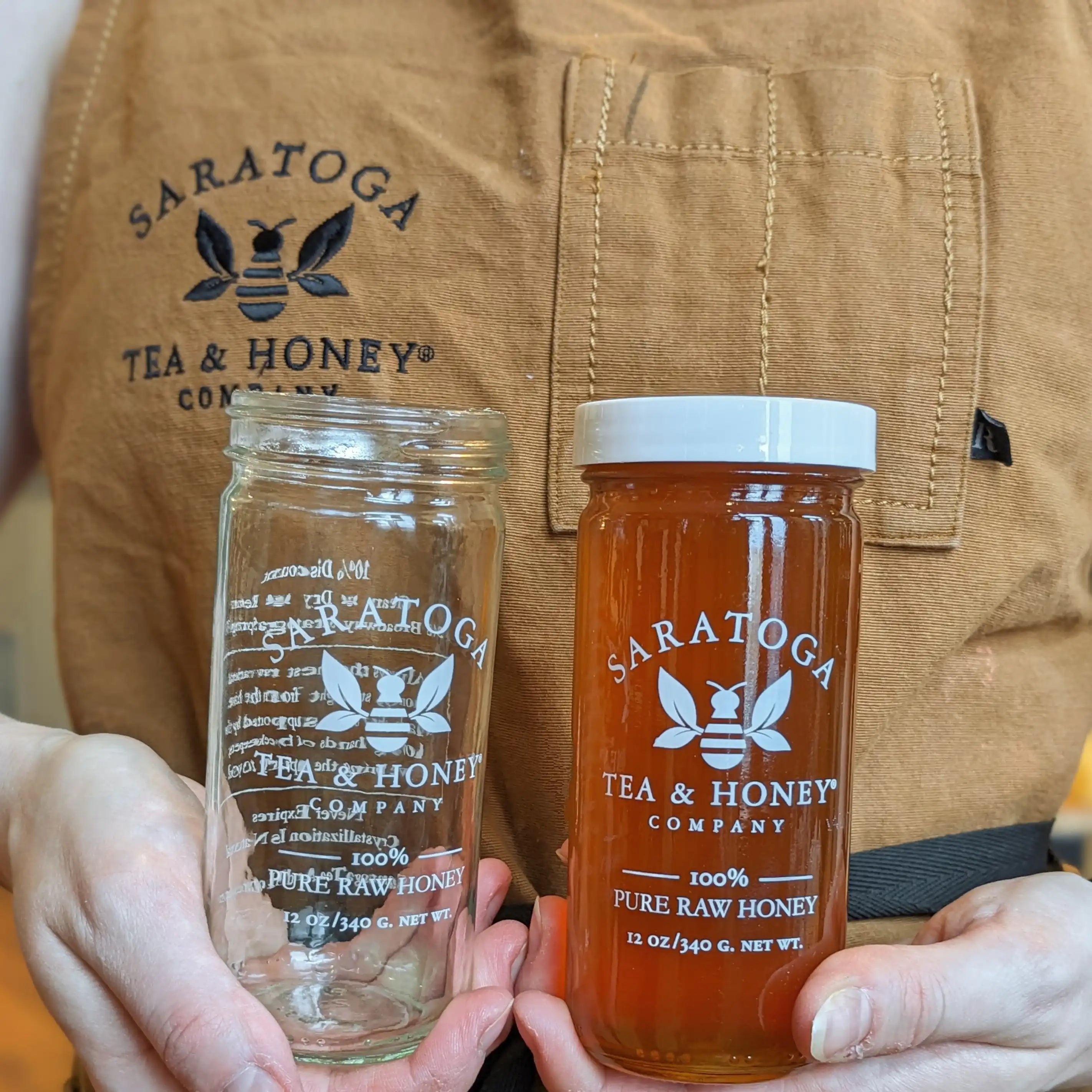 hands holding an empty and a full honey jar to symbolize the one-for-one 10% discount on honey jar returns to encourage sustainability