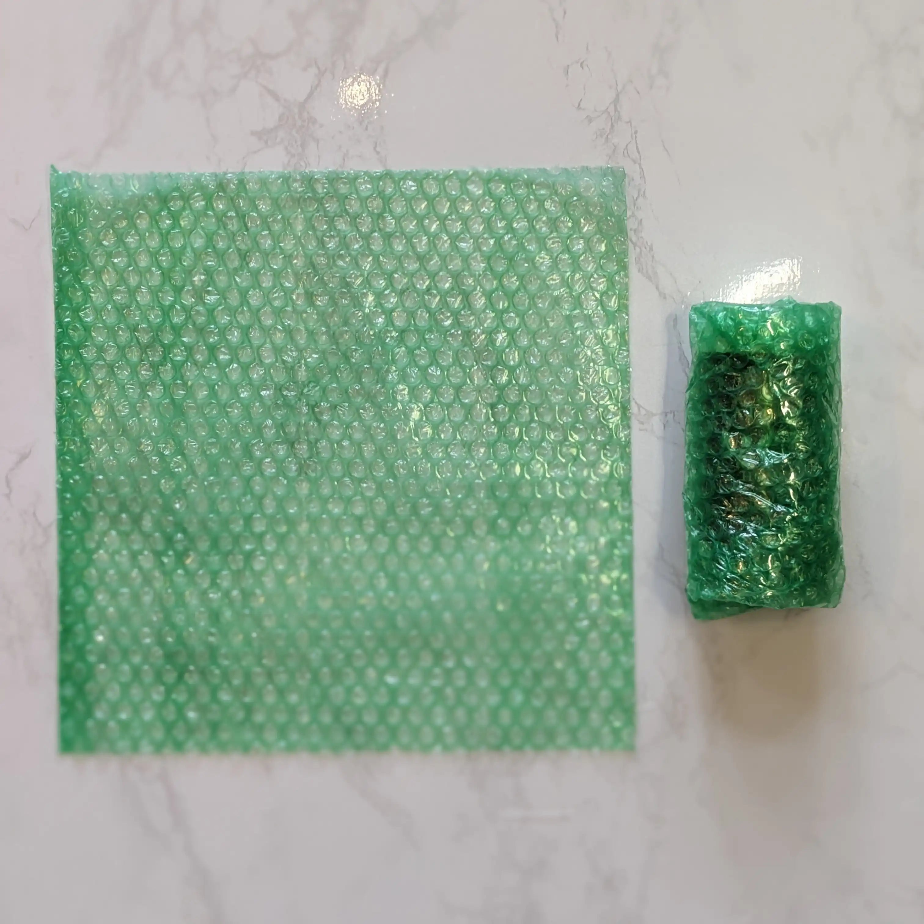 Square of recycled bubble wrap next to honey jar wrapped in recycled bubble wrap