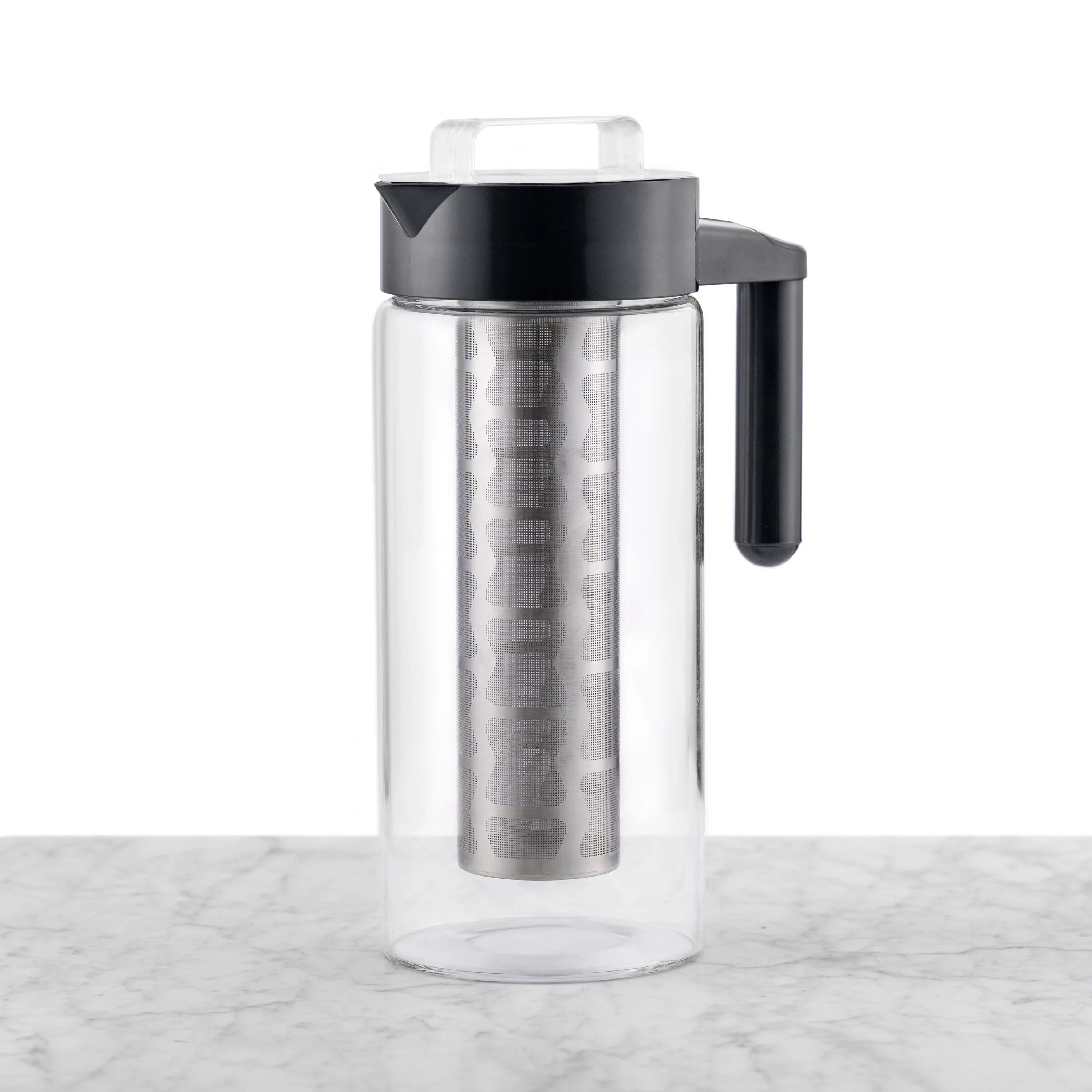 Clear glass cold tea maker featuring a black handle and lid and a removable stainless steel mesh filter.