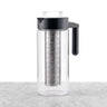 Clear glass cold tea maker featuring a black handle and lid and a removable stainless steel mesh filter.