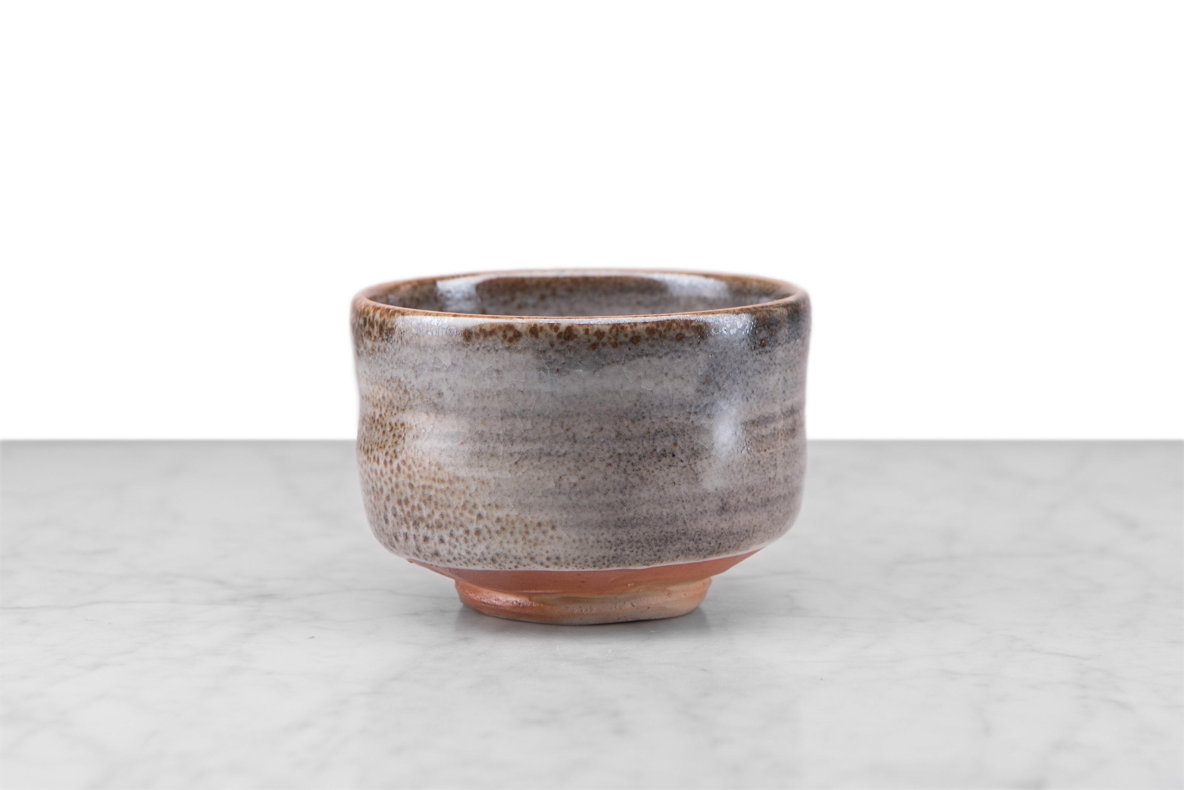 matcha chawan deep bowl with smooth, slightly curved sides in a grey and brown glaze