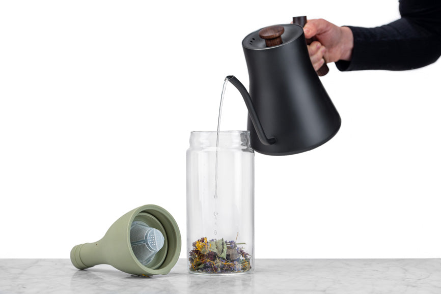 water being poured into an iced tea bottle