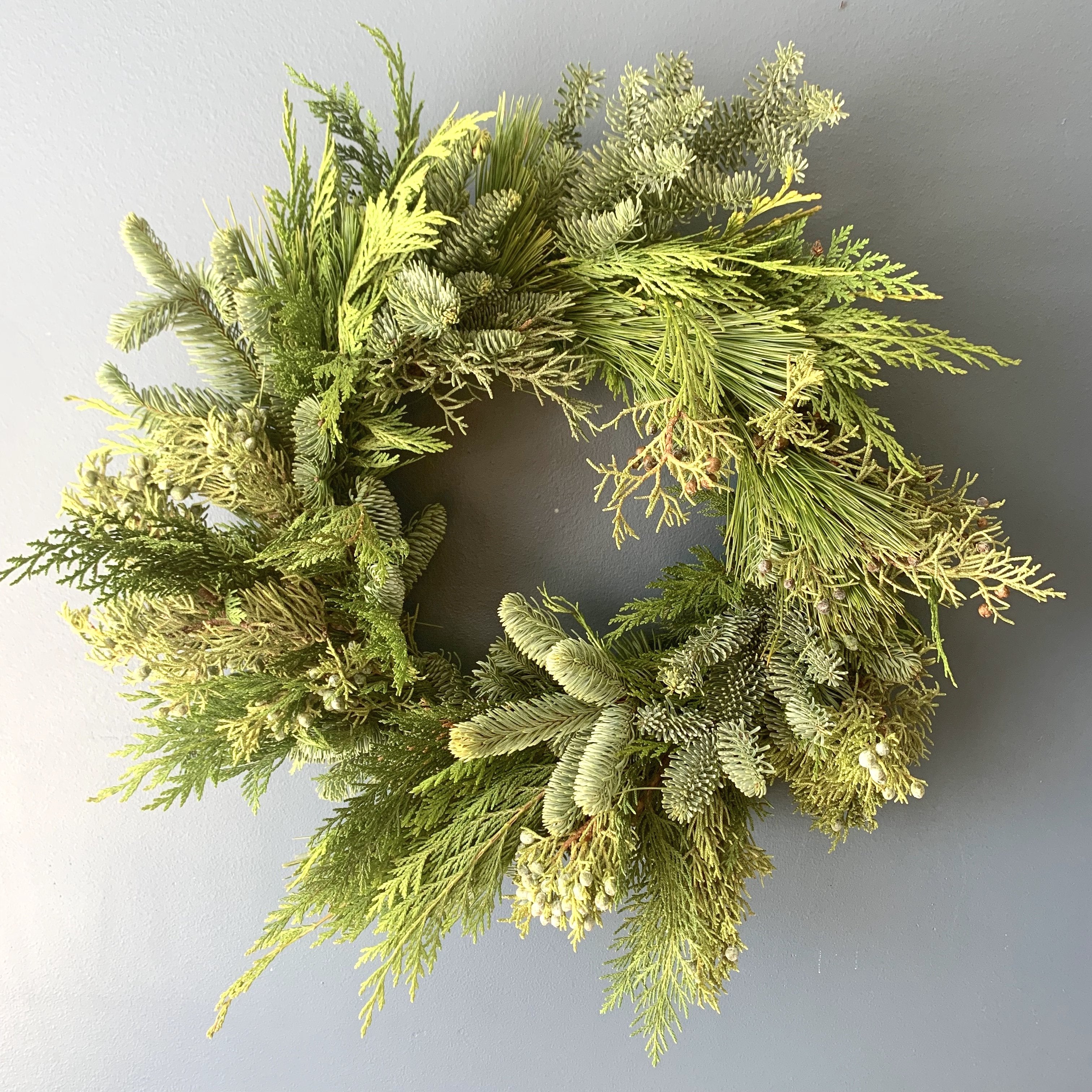 evergreen wreath on a gray wall