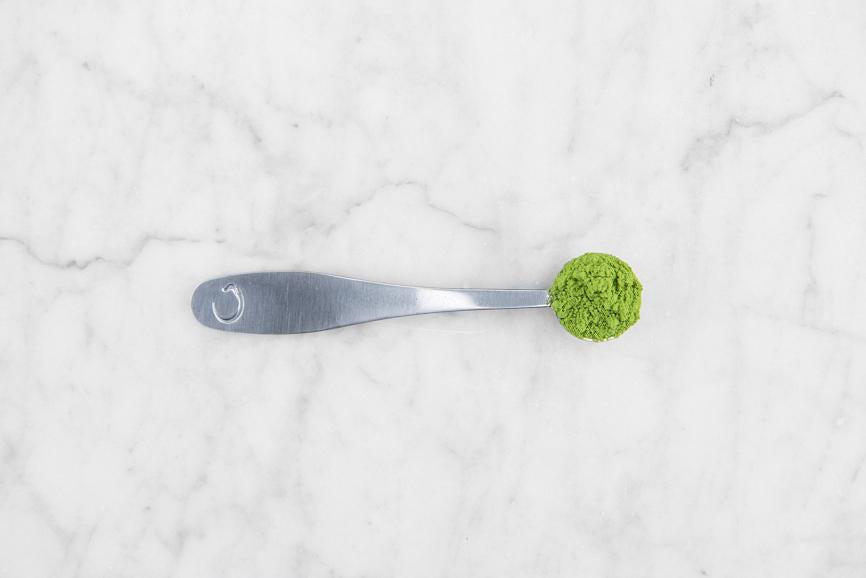 A matcha scoop full of matcha.