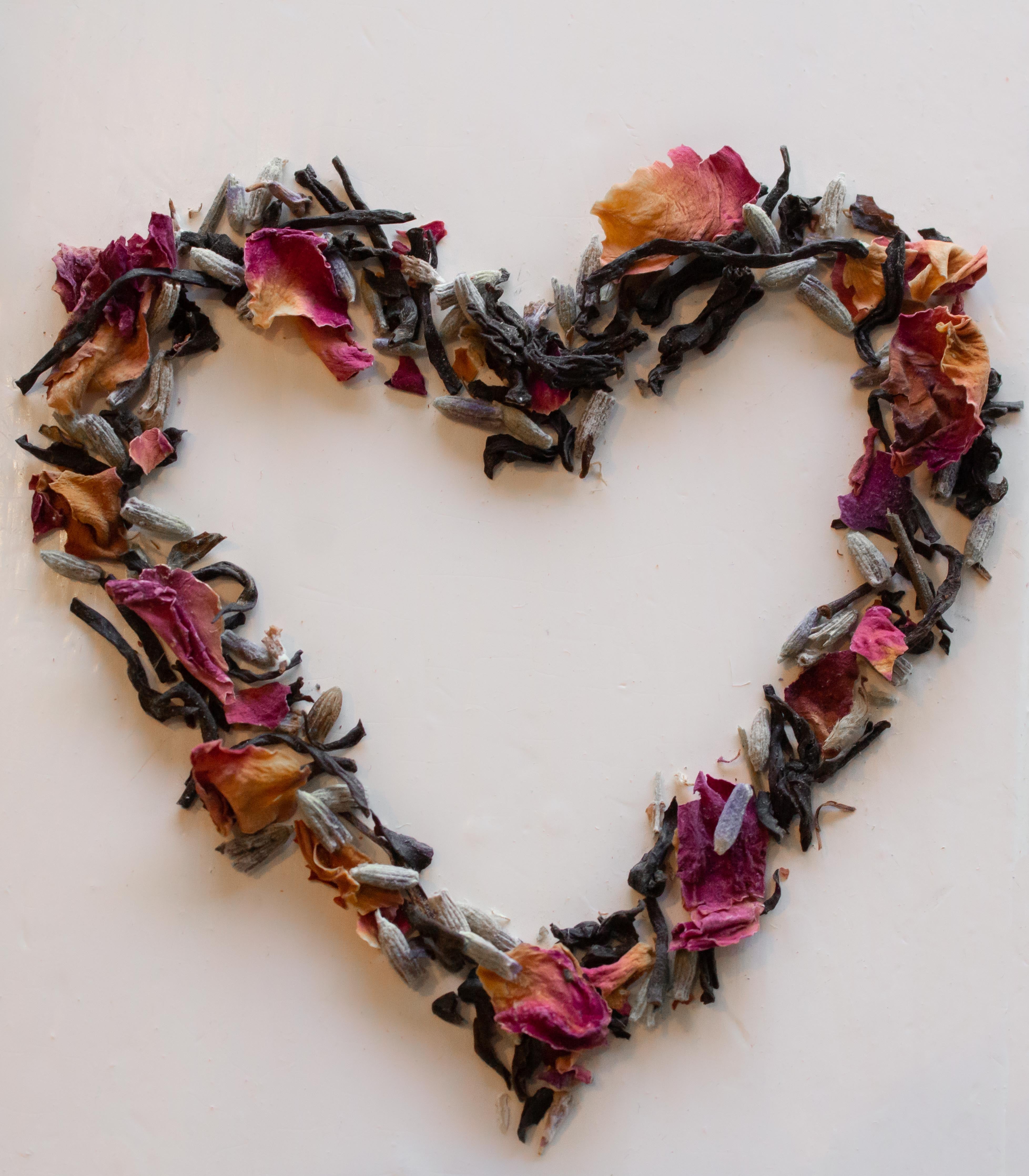 heart shaped from loose leaf Paris in Love tea on a white background