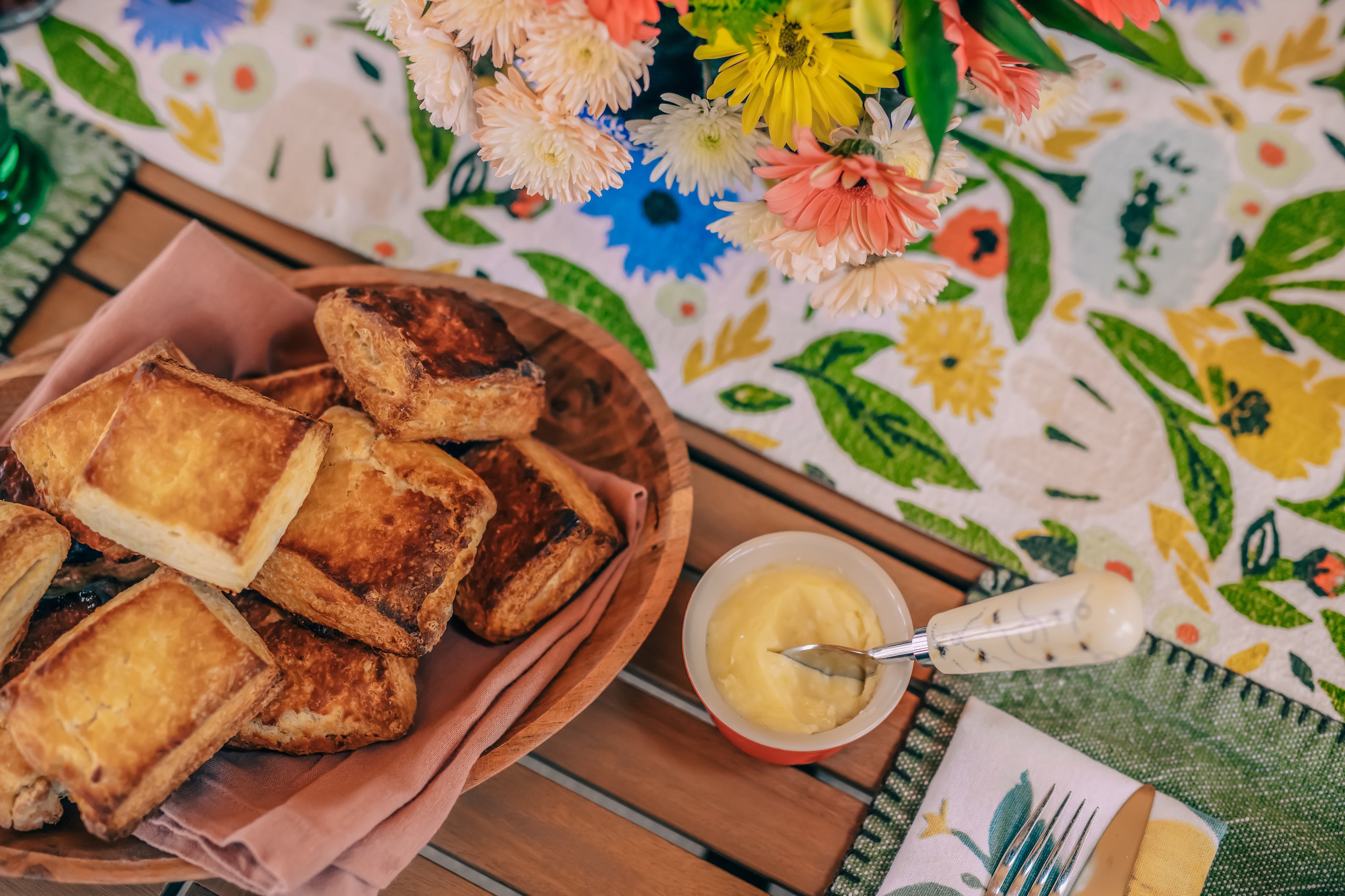 honey butter next to a platter of honey buttermilk biscuits