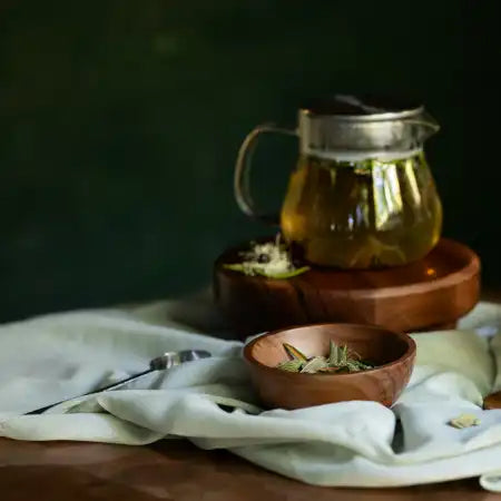 glass teapot with brewing wild foraged wild taiga herbal tisane