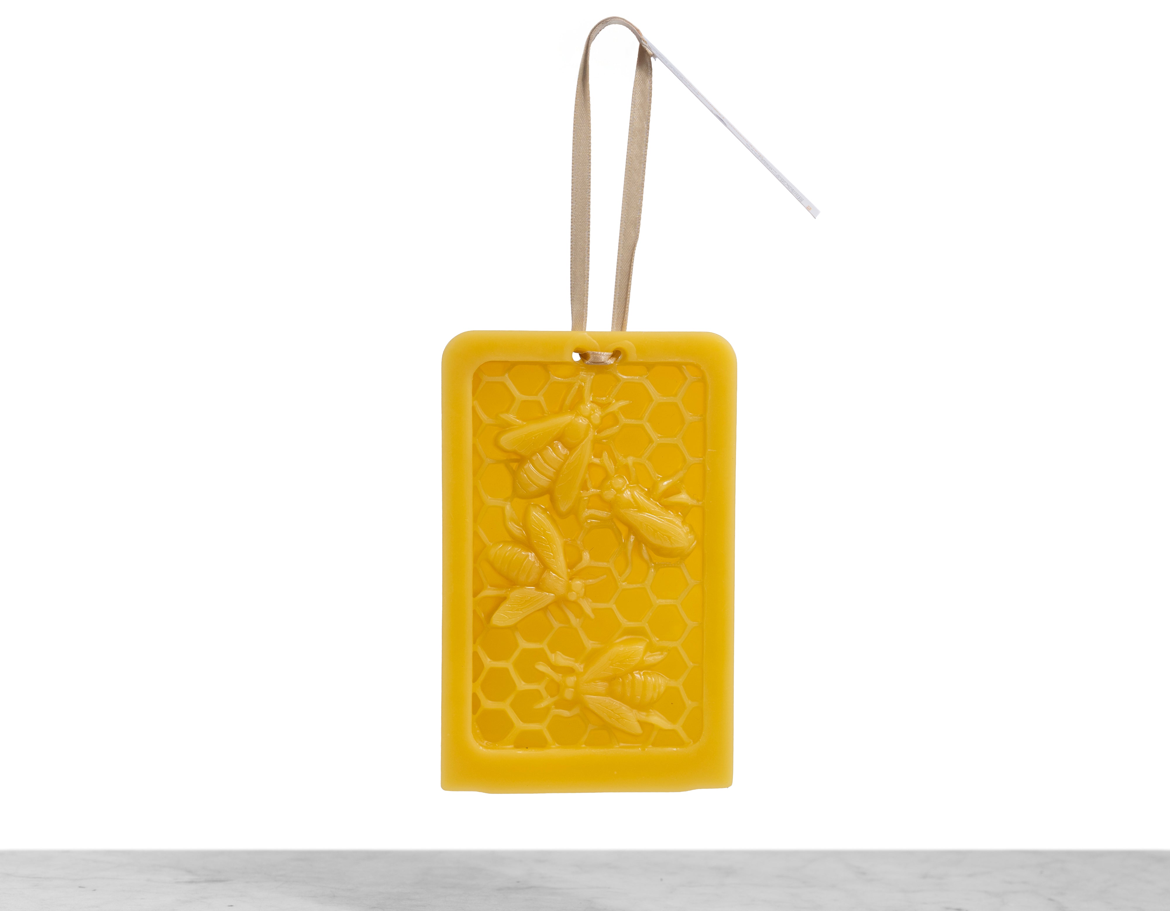 A beeswax ornament designed to look like bees in a hive.