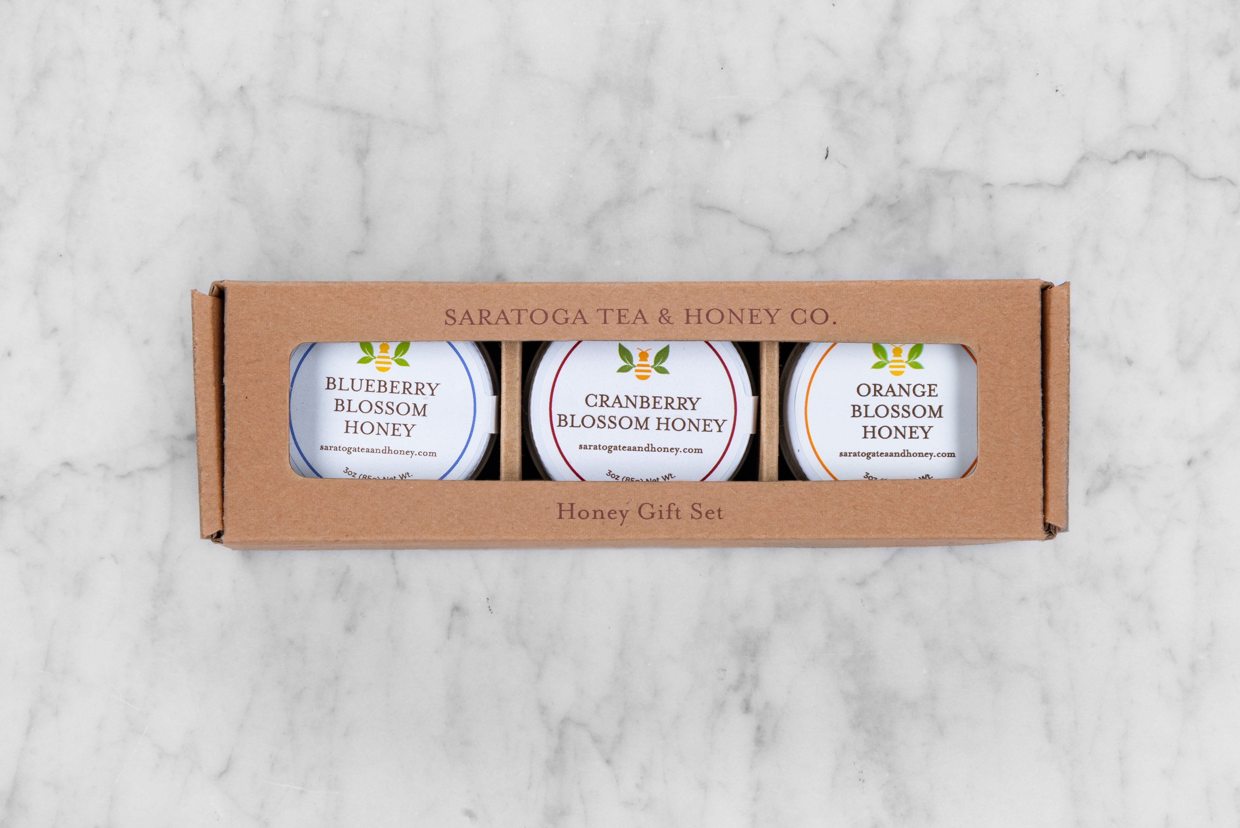 gift set of three raw blossom honeys featuring blueberry blossom, cranberry blossom, and orange blossom honeys