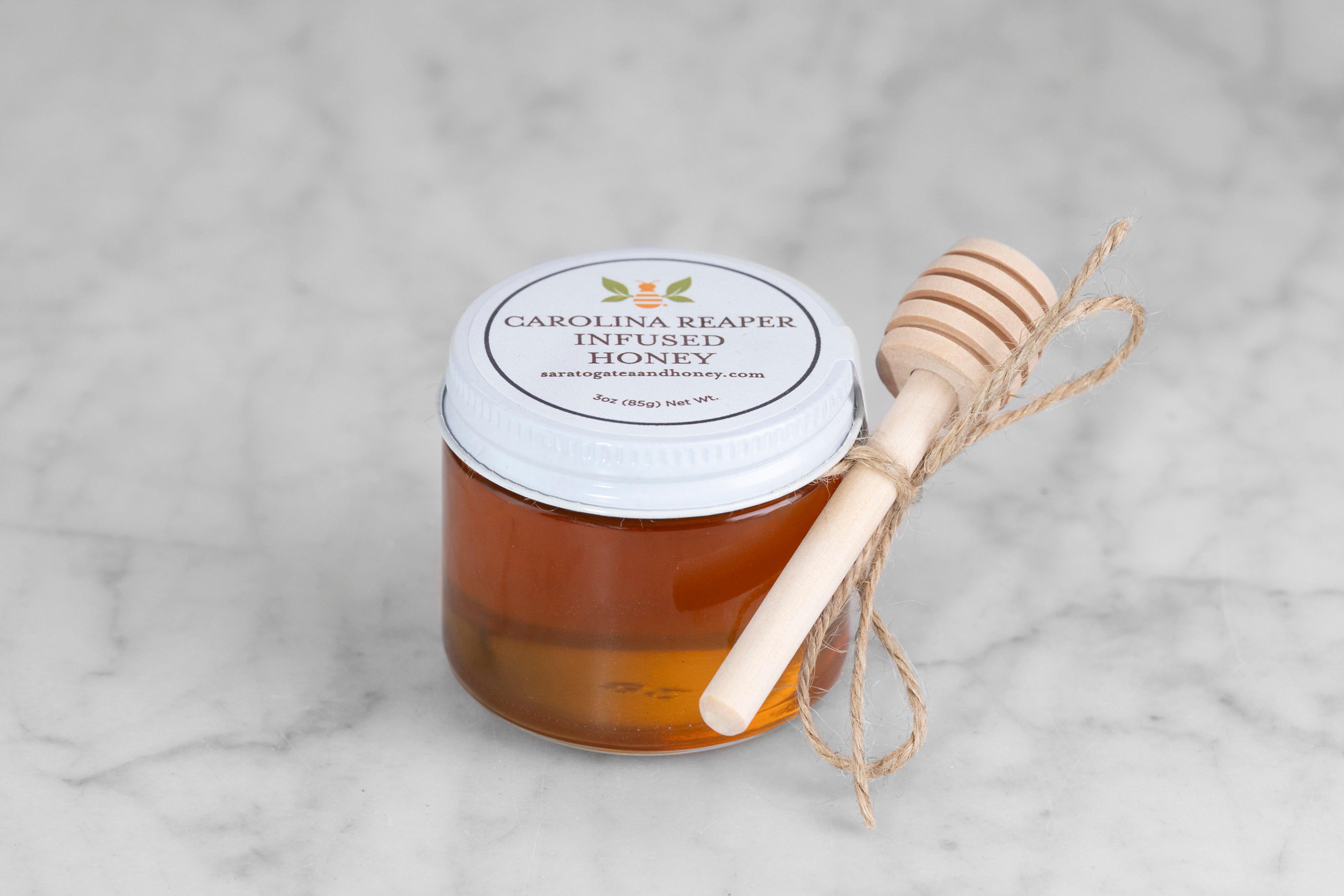 mini 3 oz jar of Carolina Reaper honey from Saratoga Tea & Honey co. with twine and mini dipper perfect for stocking stuffers or small gifts