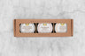 Charcuterie Mini Honey Gift Set with three mini honeys in a brown kraft box with window. From left to right: Portuguese Black Forest Honey, Sourwood Honey, Orange Blossom Honey.