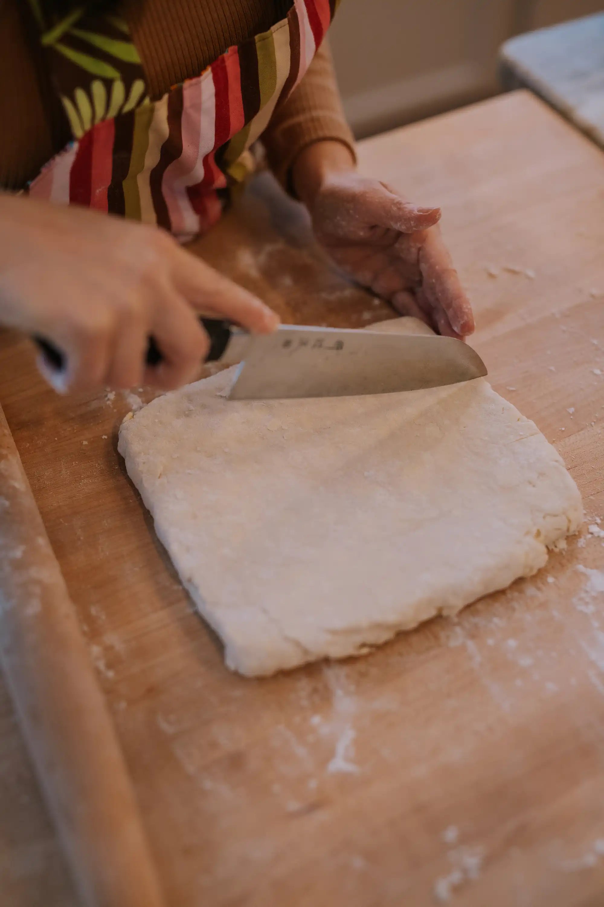 hand using knife to cut briscuits