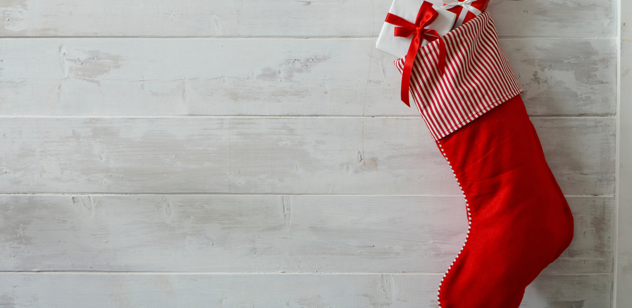 red stocking hanging against whitewashed wood