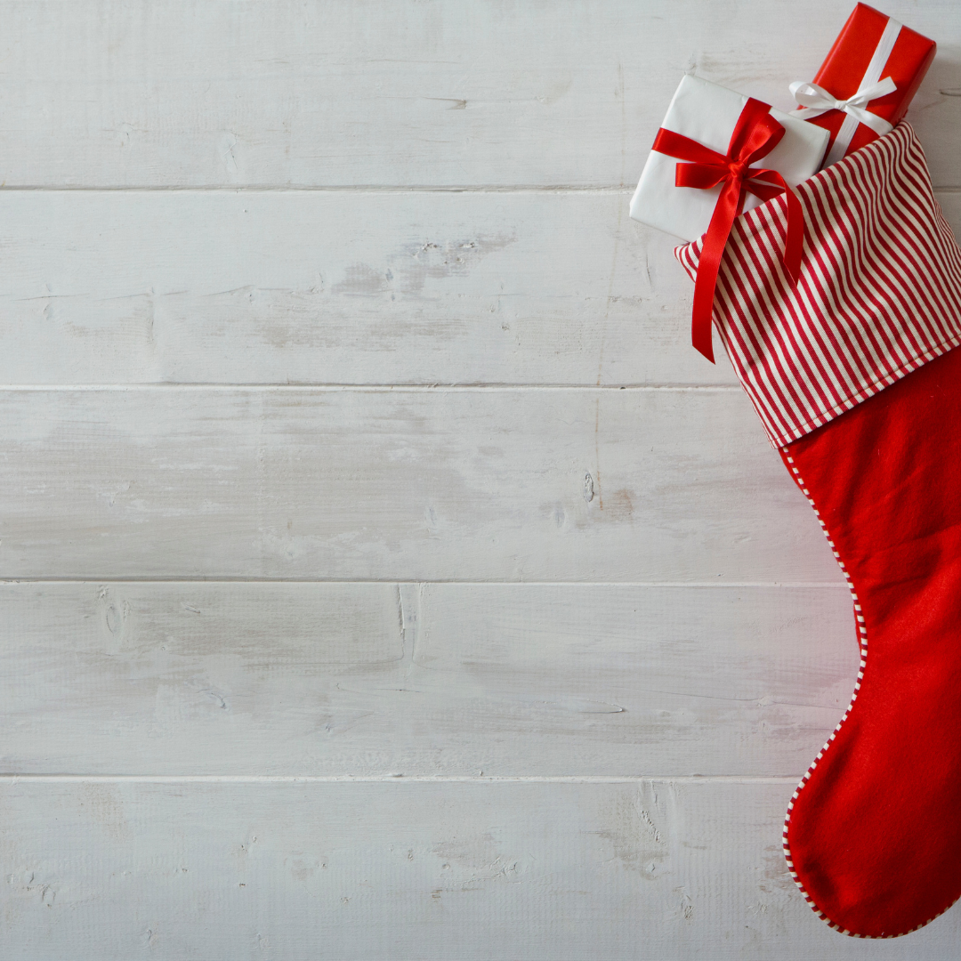 red stocking hanging against whitewashed wood