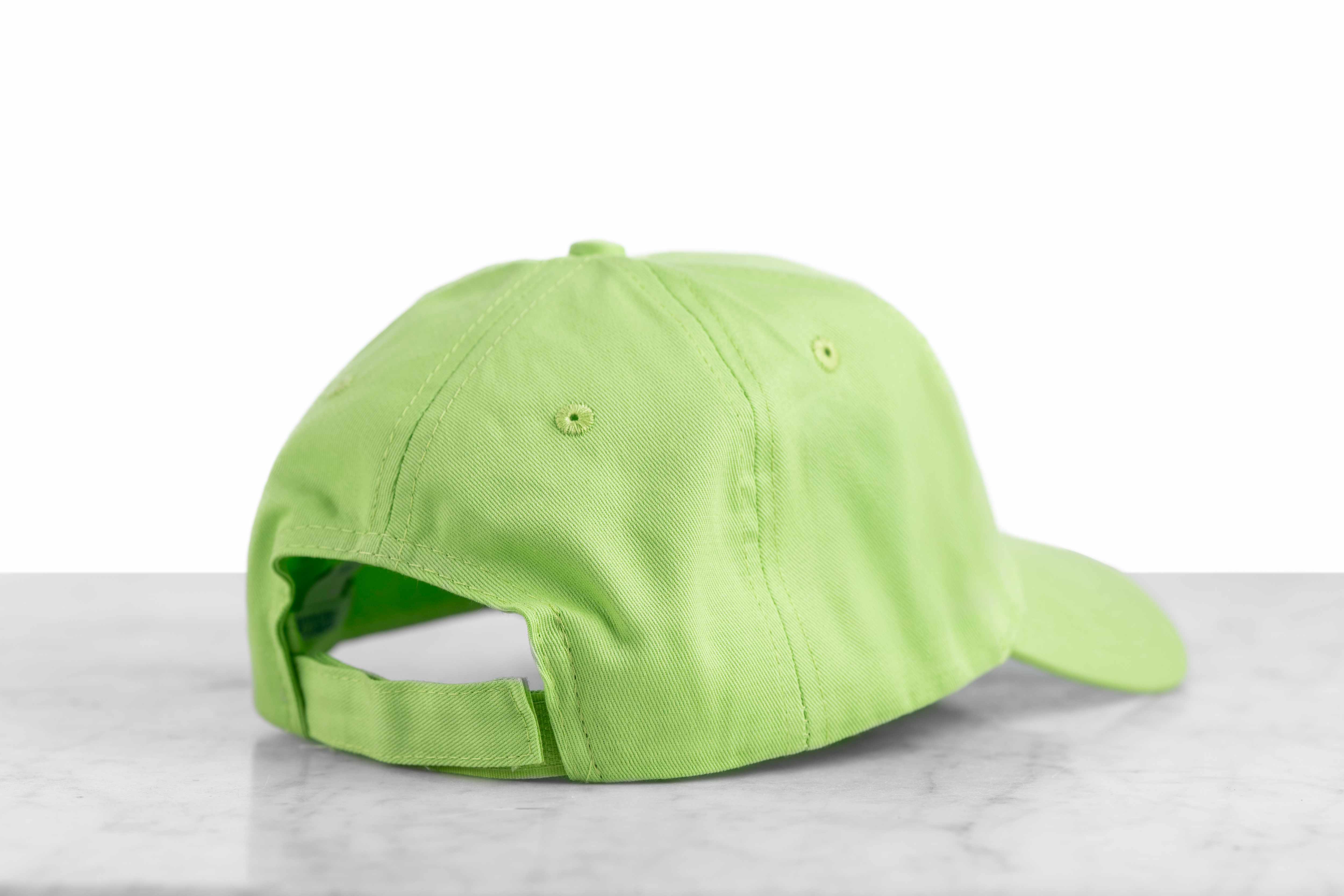 The back of a lime green baseball cap with a velcro size adjustor.