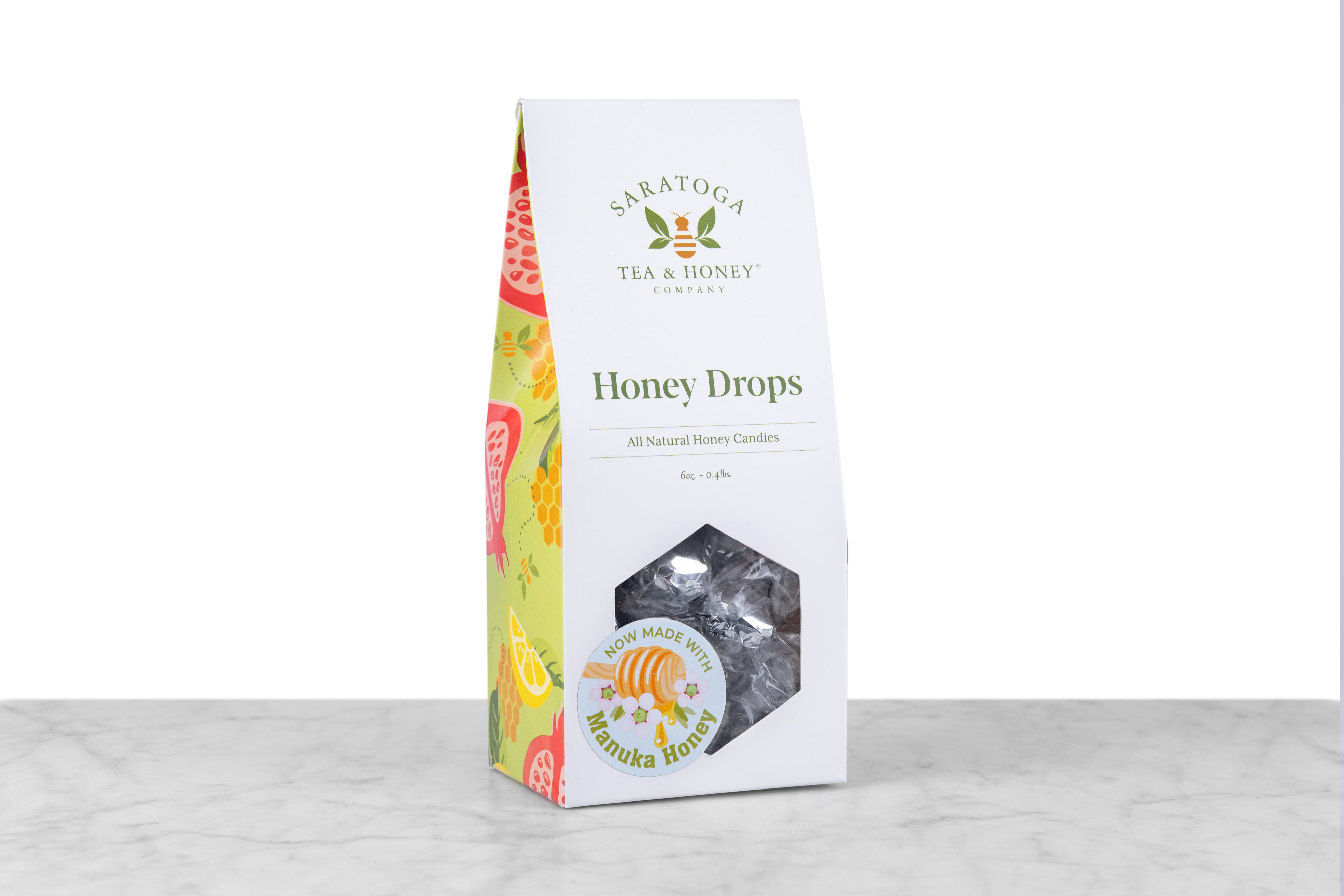 white box with window showing foil wrapped honey drops and a sticker reading now made with manuka honey