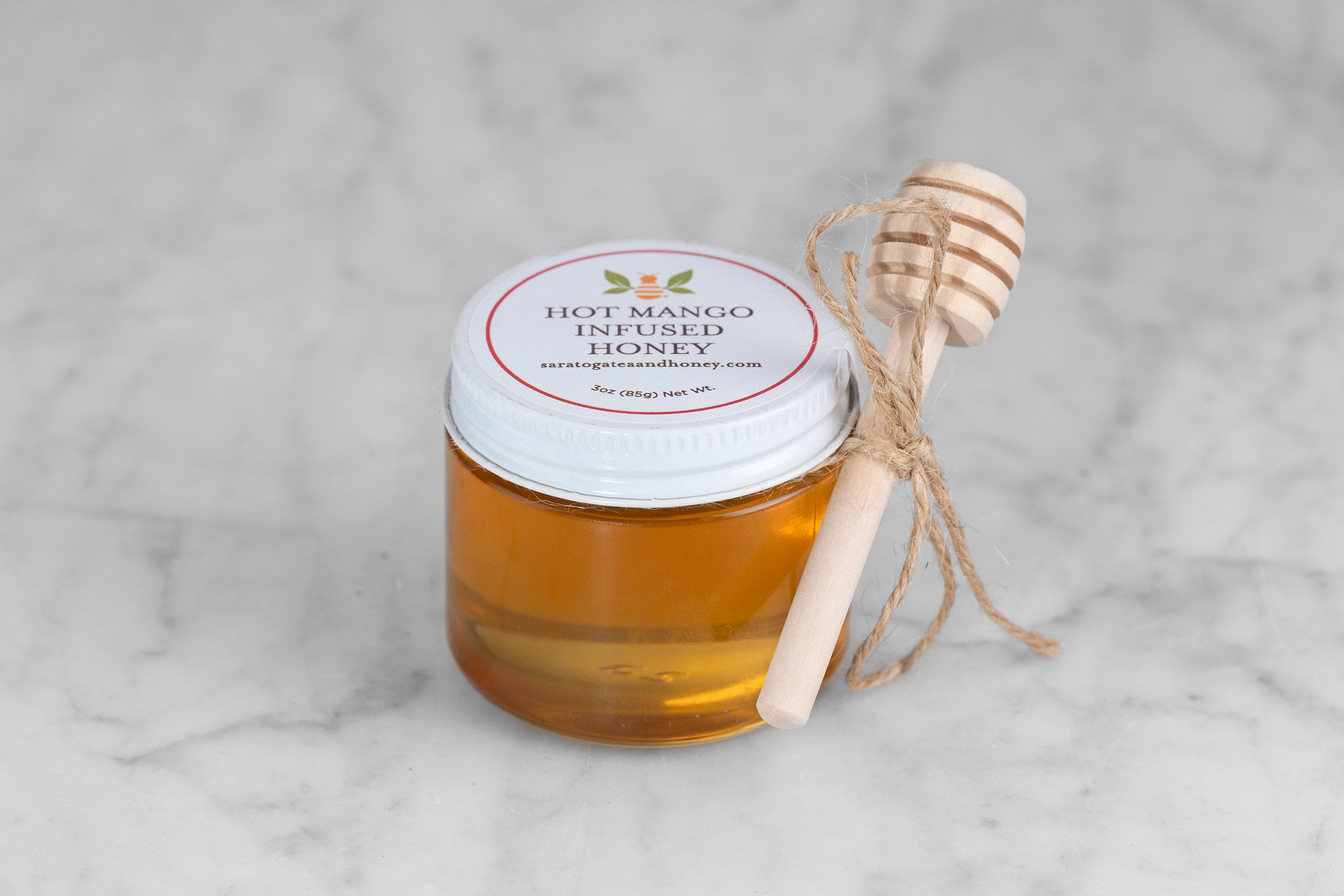 mini 3 oz jar of Hot Mango honey from Saratoga Tea & Honey co. with twine and mini dipper perfect for stocking stuffers or small gifts