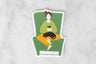 vinyl sticker of female figure sitting in a green armchair with a cat in her lap and a cup of tea in her hands