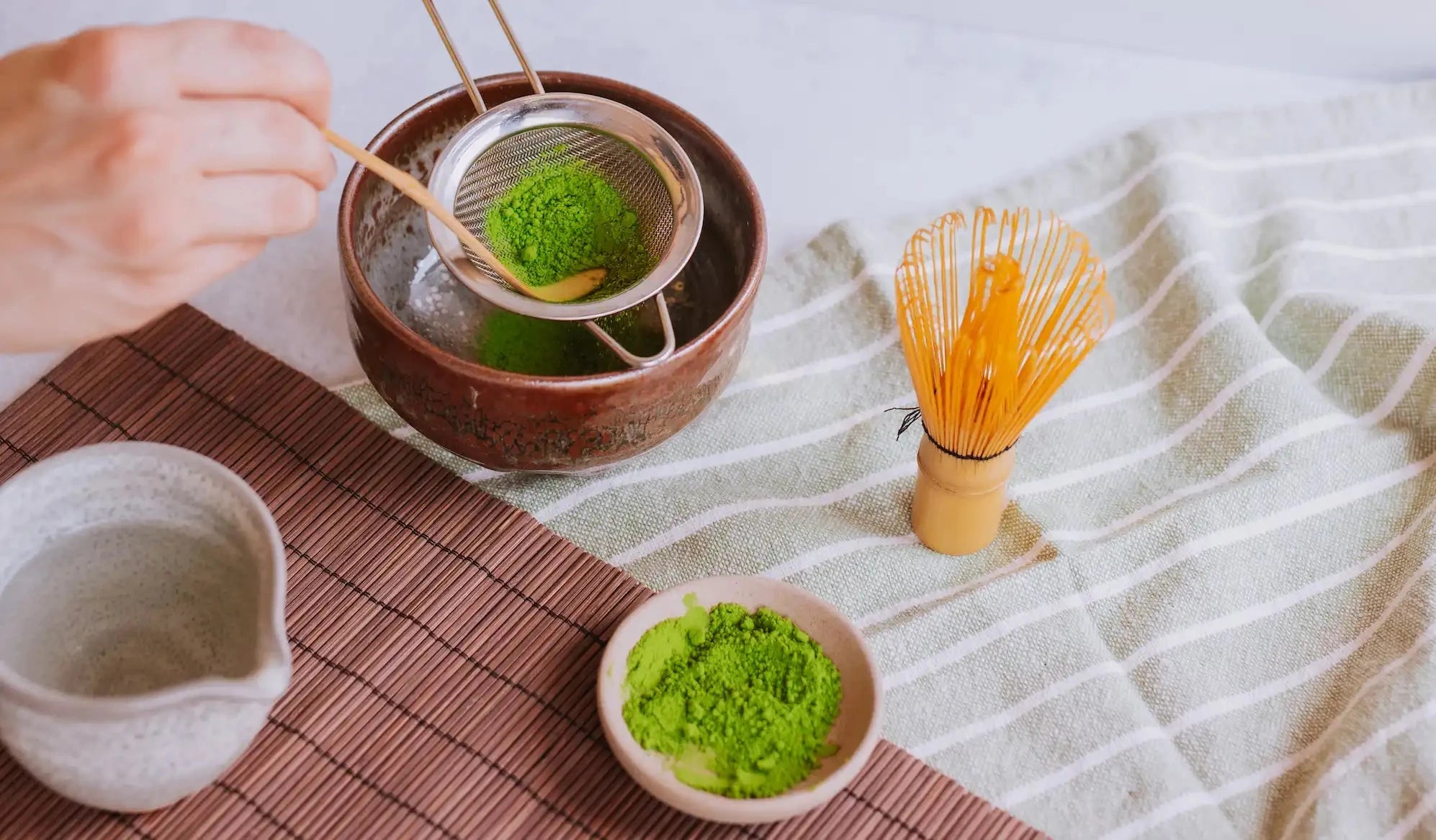 full matcha teaware collection including matcha chasen, sifter, chashaku, and chawan (matcha bowl)