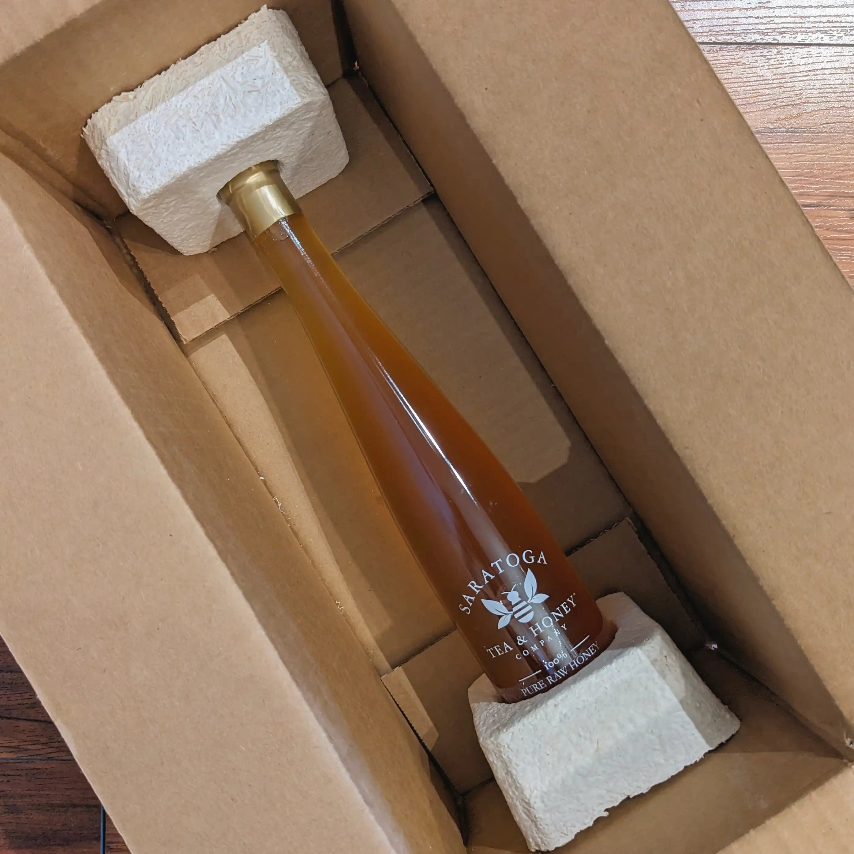 diagonal photo of tall honey jar in custom mushroom packaging