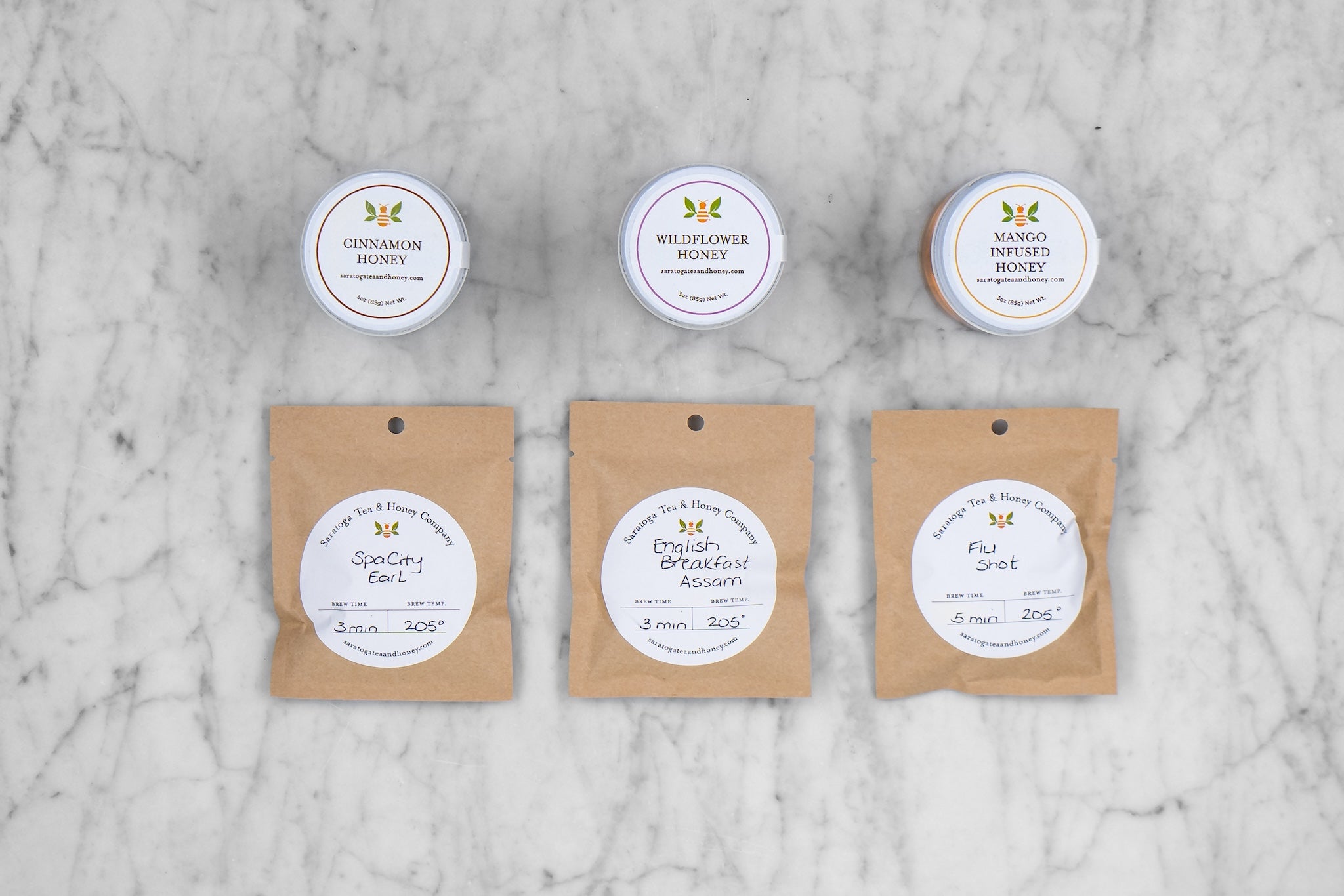 flat lay of three tea samples and three honey samples included in the new bee gift set