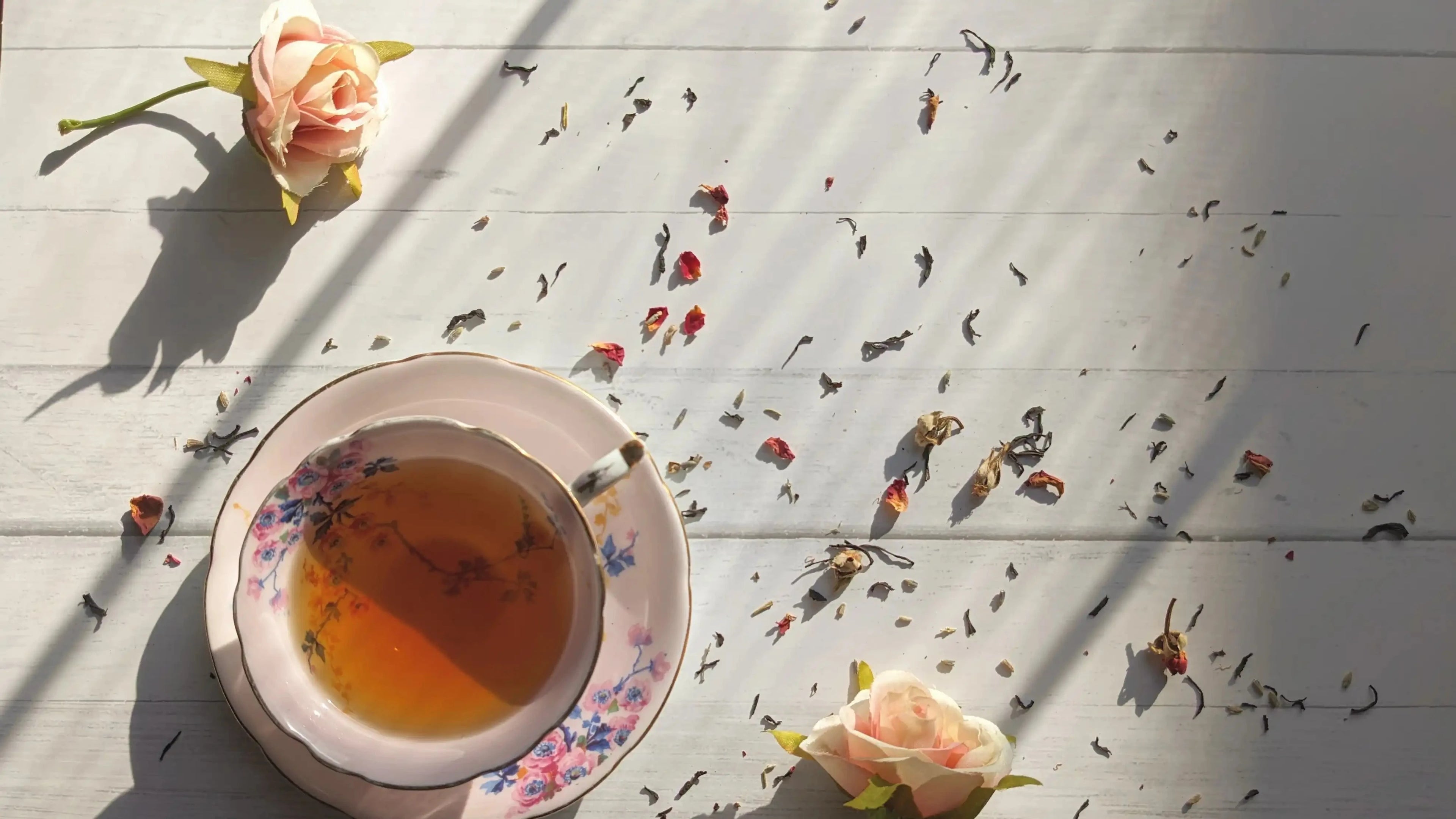 paris in love in a pink vintage teacup with scattered tea leaves