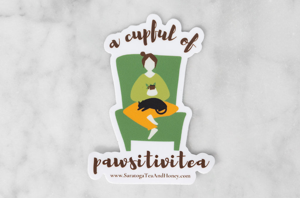 vinyl sticker with illustration of a lady sipping tea with a cat in her lap with the tea and cat pun: a cupful of paws-i-tiv-i-tea
