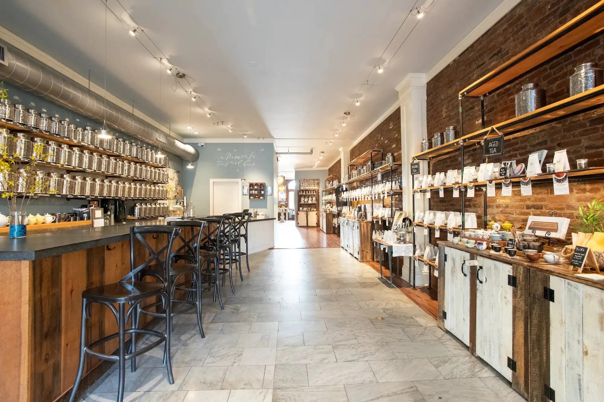interior shot of Saratoga Tea & Honey Co. looking from entrance past the Tea Bar and wall of teas into the honey room