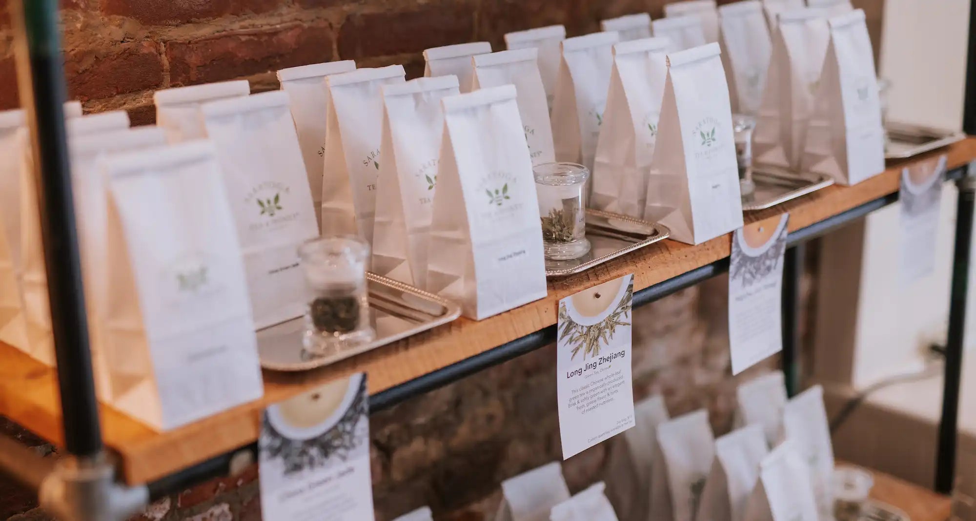 bags of loose leaf tea on the shelf at Saratoga Tea & Honey Co.