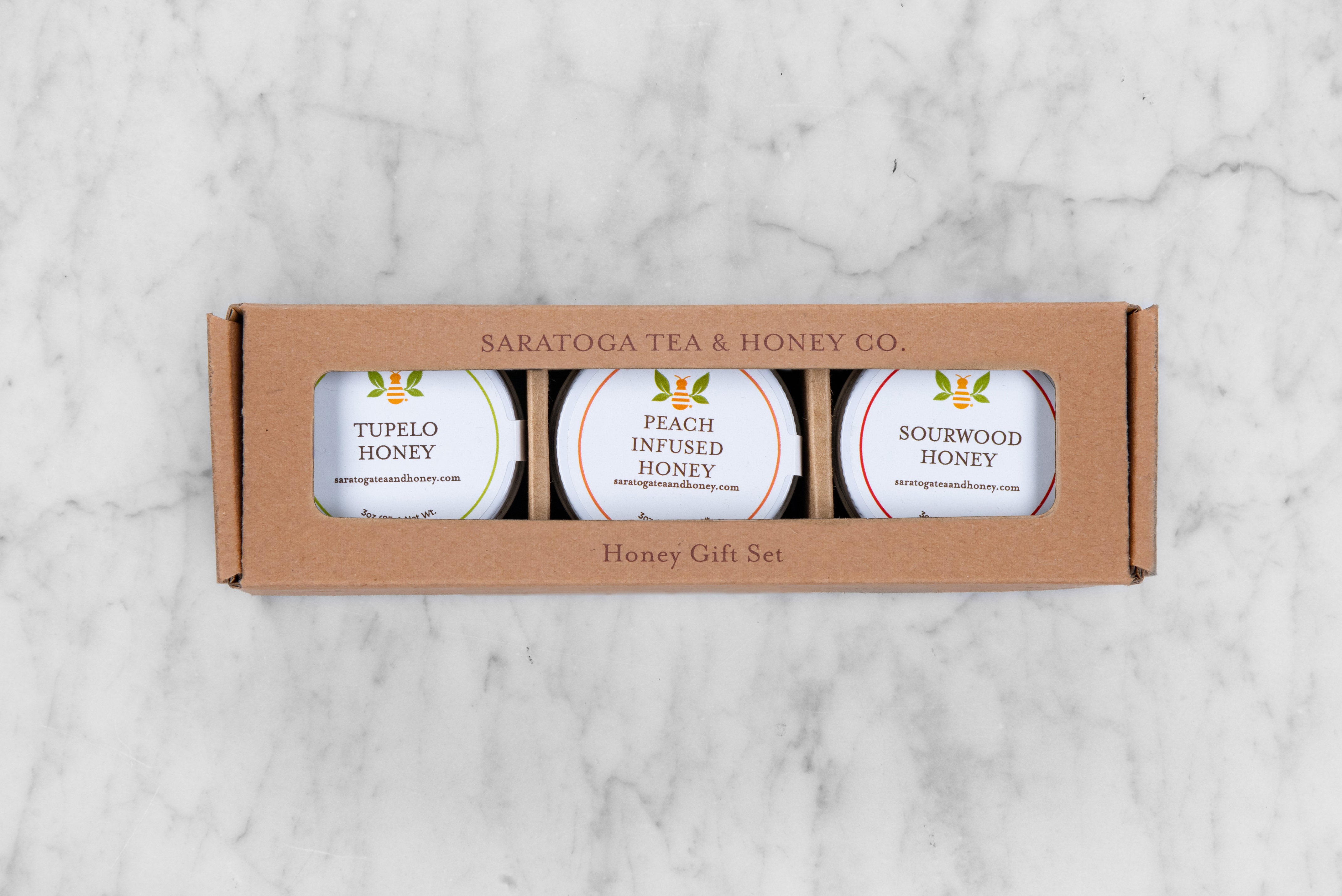 honey gift set featuring three honeys from the southern US: tupelo raw honey, peach infused honey, and sourwood raw honey
