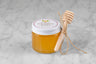 3oz jar of Sumac & Clover Honey with twine and mini dipper on a marble background