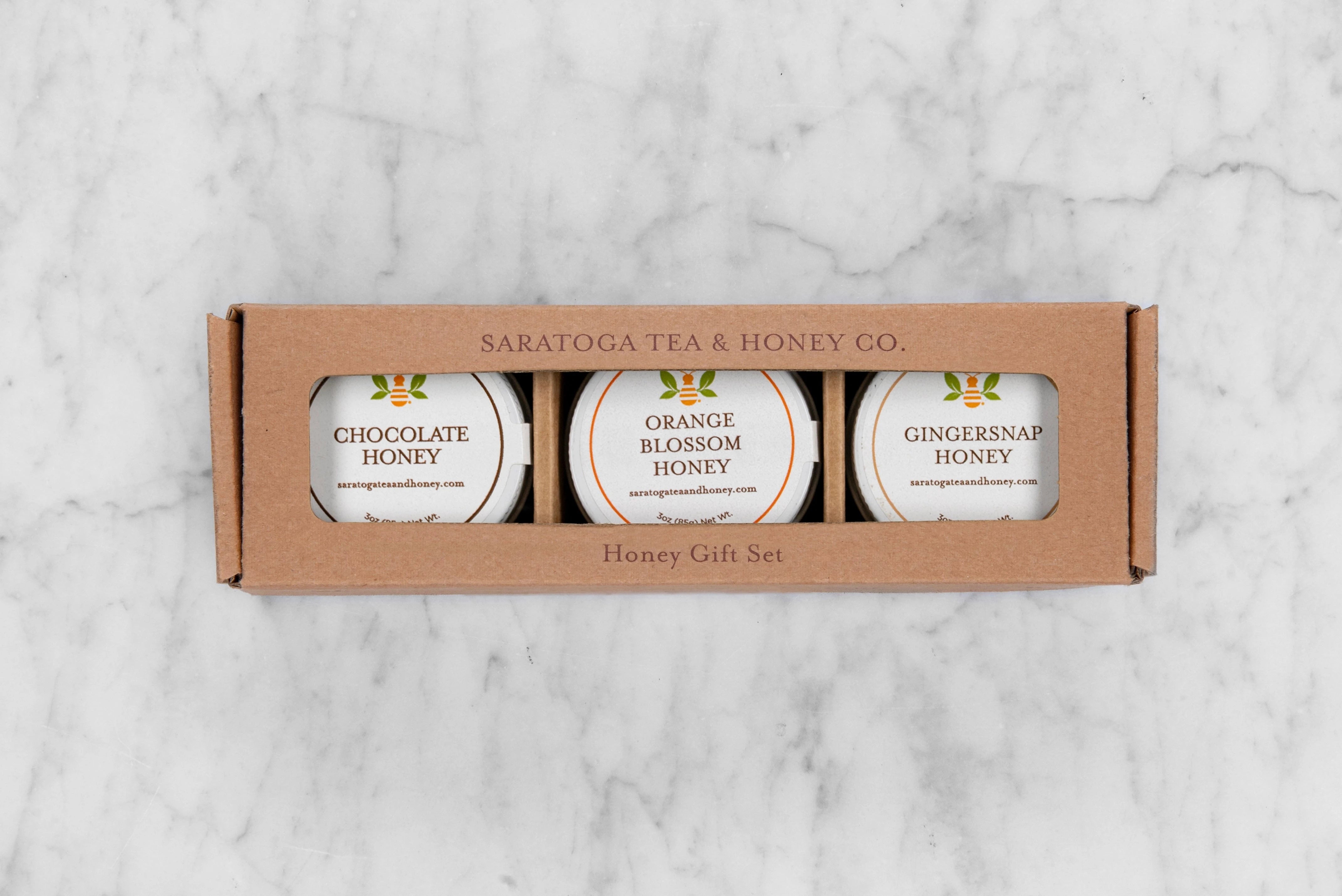 Sweater Weather 3-pack honey gift set of 3oz mini honeys. Includes Chocolate Honey, Orange Blossom Honey & Gingersnap Honey in a kraft gift box with window.