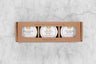 three pack honey gift set in a brown craft box reading Saratoga Tea & Honey Co. Honey Gift Set. From left to right: Gingersnap Honey, Salted Chestnut Honey, Cinnamon Honey