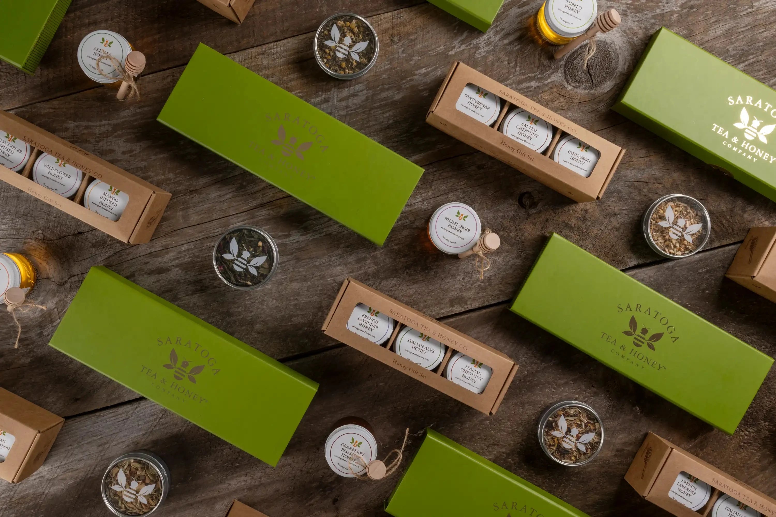 tea and honey gift sets on a diagonal on a wooden background