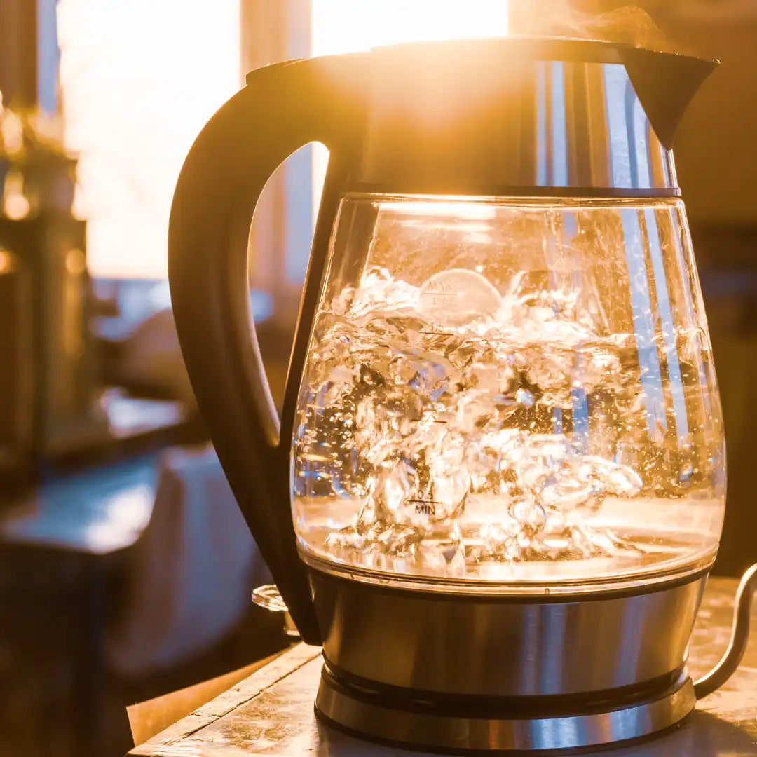 water boiling in a glass tea kettle