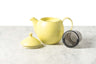 showing three main parts of the dew teapot in lemongrass yellow: lid with silicone ring, teapot, and stainless steel basket infuser