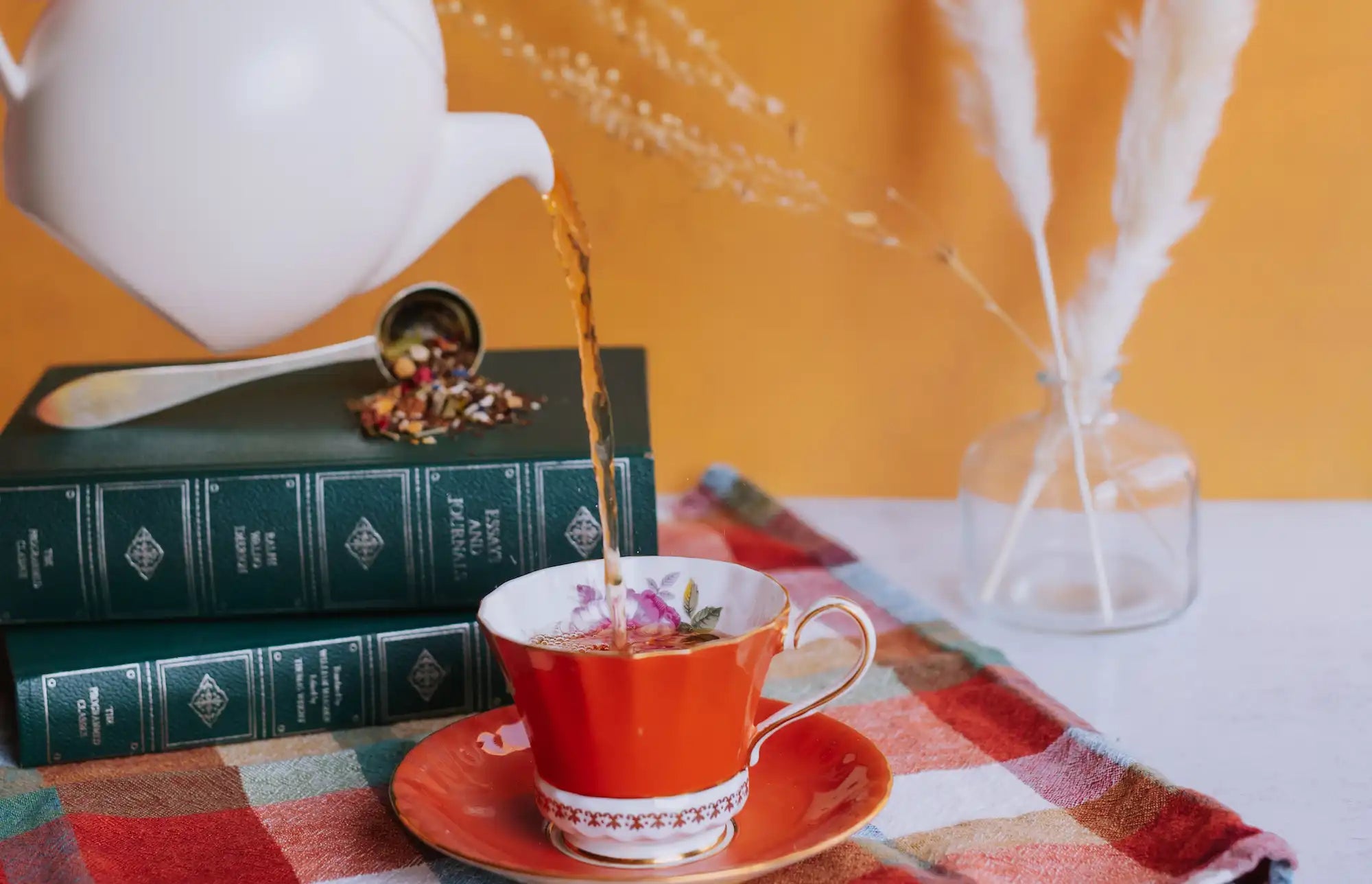 pouring spirit of life cirtus herbal into an orange vintage teacup