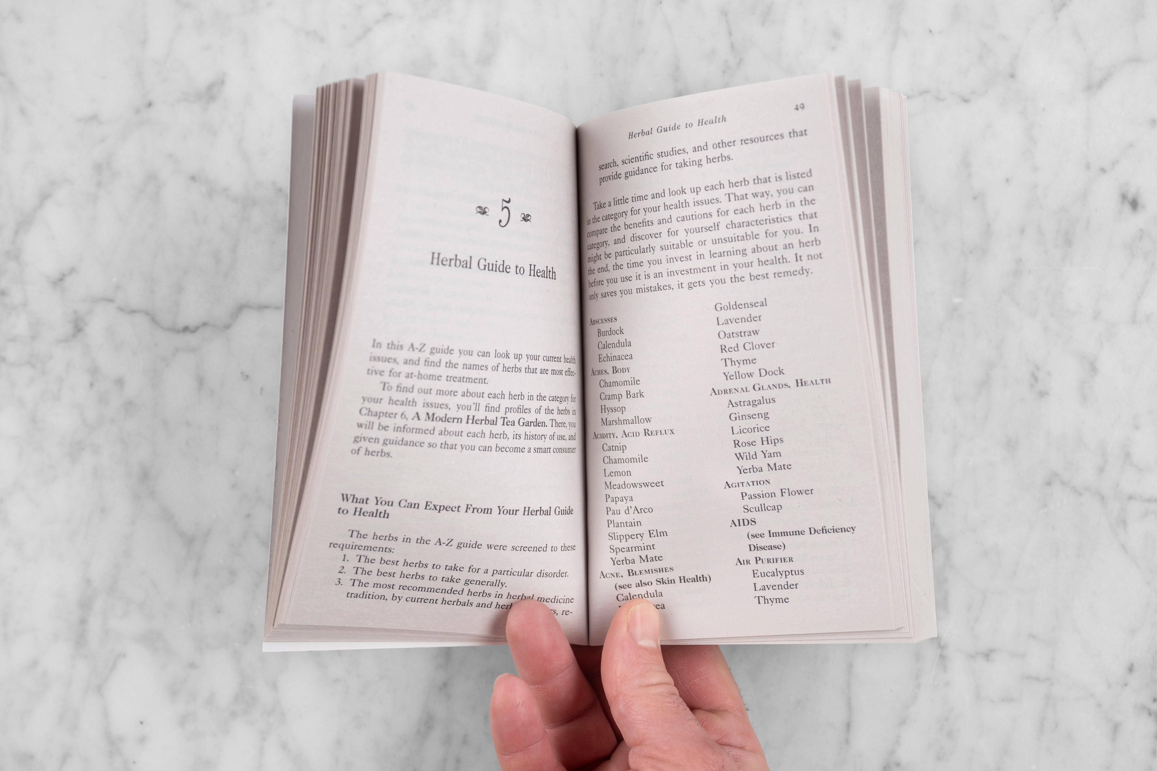 A small book opened to a chapter titled "Herbal Guide to Health".
