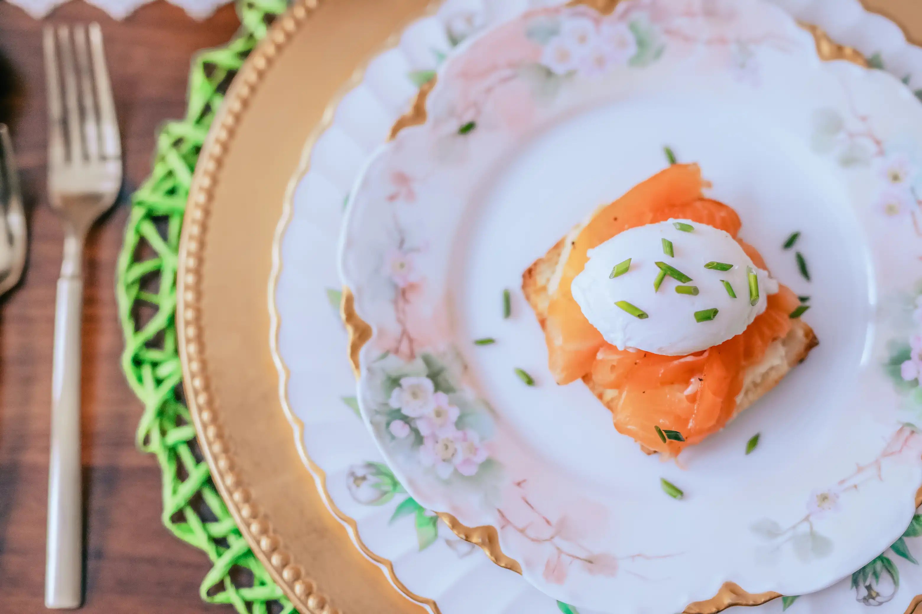 tea cured salmon on a biscuit with a poached egg
