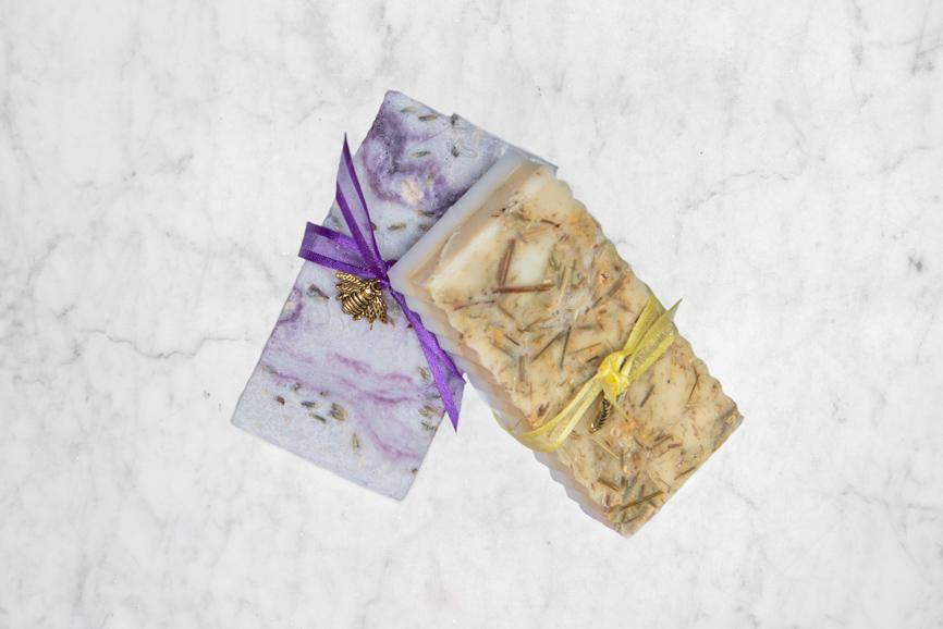 top down of lavender and ginger lemon soaps on marble background