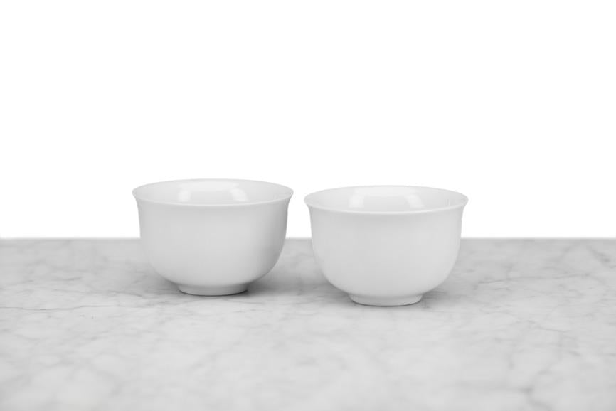 two small Japanese-style white tea cups with no handle