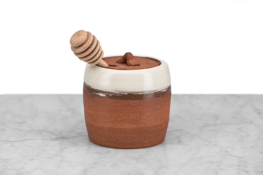 rustic clay honeypot with wooden dipper