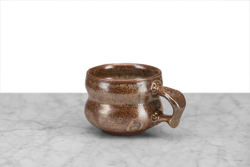 hand thrown local NY pottery brown tea or coffee mug with beveled sides and a thumbprint handle