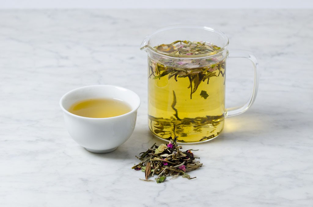 delicately scented rose and lavender white tea infused in a glass beaker and white cup