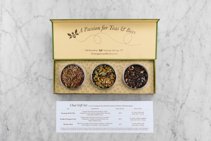 three pack gift set of chai teas in a green and yellow gift box with a white card showing the name, ingredients, brew temp and brew time for each tea