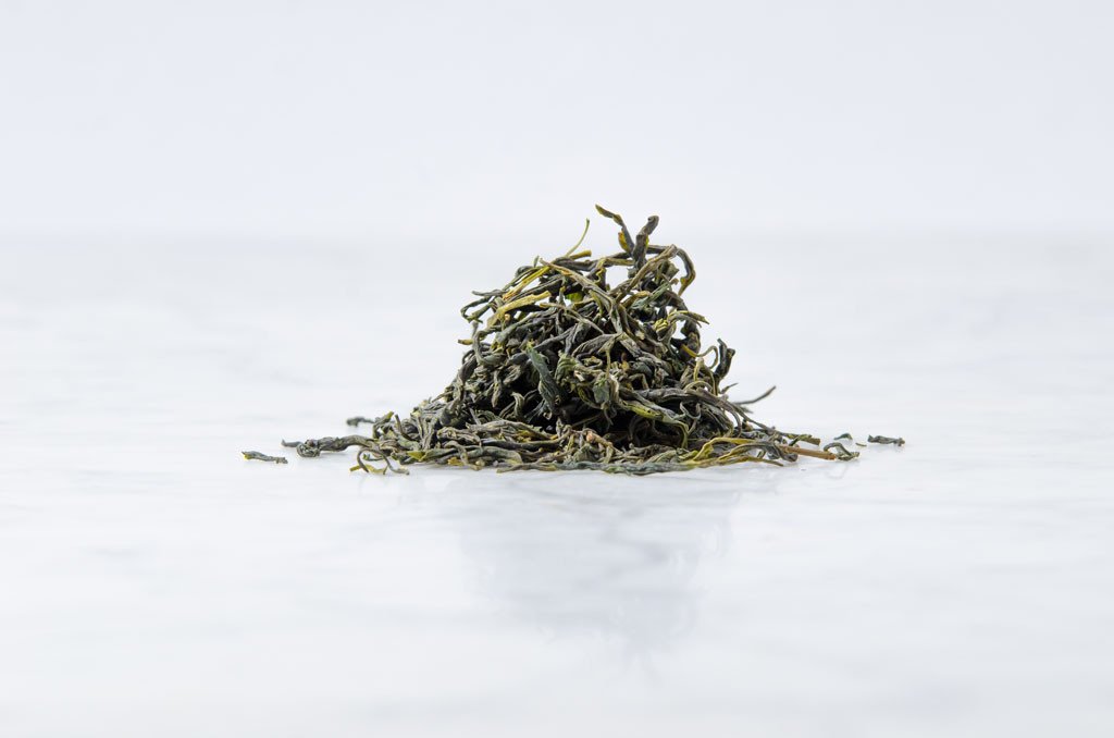 loose leaf Chinese green tea on a marble background