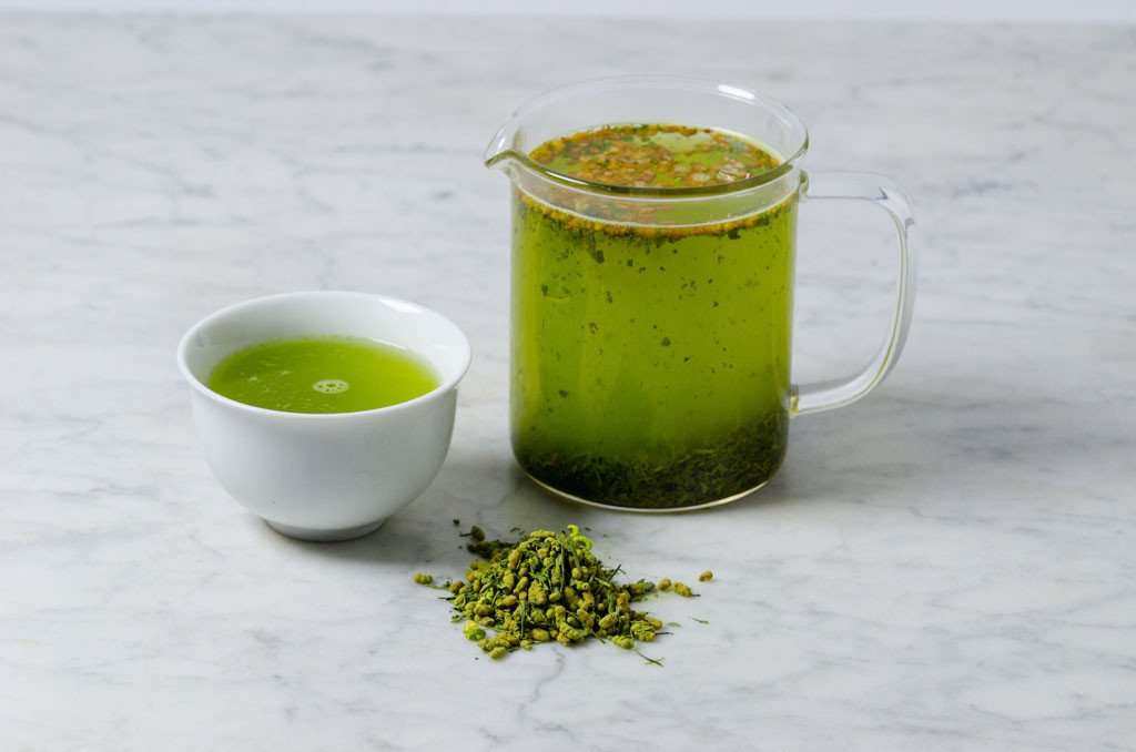 genmai cha sencha matcha loose leaf green tea brewed in a glass infuser and served in a white cup